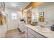Bright bathroom featuring double sinks, framed mirror, walk-in closet, and a glass-enclosed shower at 794 Calm Crystal Ct # Lot 139, North Las Vegas, NV 89081