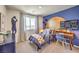Unique bedroom featuring sporty decor, blue accent wall, desk, and a comfortable single bed at 794 Calm Crystal Ct # Lot 139, North Las Vegas, NV 89081