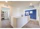 Upstairs hallway with doorways leading to bedrooms and office space, plus neutral carpet and decor at 794 Calm Crystal Ct # Lot 139, North Las Vegas, NV 89081