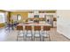 Modern open kitchen featuring a large center island with seating, stainless appliances, and view into the dining area at 794 Calm Crystal Ct # Lot 139, North Las Vegas, NV 89081