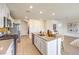 Clean kitchen featuring a center island with seating, stainless appliances, and light-colored cabinets and countertops at 794 Calm Crystal Ct # Lot 139, North Las Vegas, NV 89081