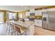Bright kitchen boasts an island with bar stool seating, white cabinetry and stainless steel appliances at 794 Calm Crystal Ct # Lot 139, North Las Vegas, NV 89081