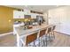 Modern kitchen with white cabinets, stainless steel appliances, a large island with bar seating, and quartz countertops at 794 Calm Crystal Ct # Lot 139, North Las Vegas, NV 89081
