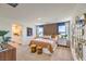Comfortable main bedroom featuring neutral carpet, natural light, and a view of the en-suite bathroom with double sinks at 794 Calm Crystal Ct # Lot 139, North Las Vegas, NV 89081