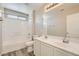 Bathroom featuring dual sinks, tile floors, and shower-tub combo at 8469 Cheerful Brook Ave, Las Vegas, NV 89143