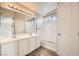Modern bathroom features large mirror, dual sinks, tiled shower and tub at 8469 Cheerful Brook Ave, Las Vegas, NV 89143