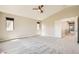 Large bedroom with plush carpet, three windows, and neutral colored walls at 8469 Cheerful Brook Ave, Las Vegas, NV 89143