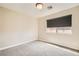 Neutral colored bedroom has carpeted floors, window with shade, and modern lighting at 8469 Cheerful Brook Ave, Las Vegas, NV 89143