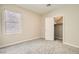 Bright bedroom features neutral walls, carpet, window, and an open closet at 8469 Cheerful Brook Ave, Las Vegas, NV 89143