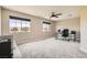 Spacious bonus room with natural light from dual windows and a ceiling fan at 8469 Cheerful Brook Ave, Las Vegas, NV 89143