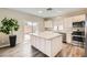 Modern kitchen with a large island, stainless steel appliances, and granite countertops at 8469 Cheerful Brook Ave, Las Vegas, NV 89143