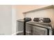 Modern laundry room featuring front load washer and dryer units at 8469 Cheerful Brook Ave, Las Vegas, NV 89143
