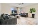Cozy living room with modern furniture, a ceiling fan, and plenty of natural light at 8469 Cheerful Brook Ave, Las Vegas, NV 89143