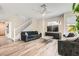 Comfortable living room with neutral tones, ceiling fan, and staircase access at 8469 Cheerful Brook Ave, Las Vegas, NV 89143