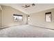 This main bedroom offers vaulted ceilings, ceiling fan, and three windows at 8469 Cheerful Brook Ave, Las Vegas, NV 89143