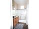Bathroom with tile flooring, tub with sliding glass doors, and wood vanity at 9303 Gilcrease Ave # 1077, Las Vegas, NV 89149
