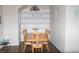 Spacious dining area features wood flooring, a decorative chandelier, and an 'EAT' accent wall, great for gatherings at 9303 Gilcrease Ave # 1077, Las Vegas, NV 89149
