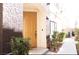 Front door with walkway, rock facade, and greenery at 9303 Gilcrease Ave # 1077, Las Vegas, NV 89149