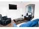 Comfortable living room with a mounted TV, wood floors, and cozy seating, creating a relaxing space for entertainment at 9303 Gilcrease Ave # 1077, Las Vegas, NV 89149