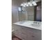 Bathroom featuring a double sink vanity, bright lighting, and separate shower at 951 Country Back Rd, Las Vegas, NV 89123