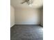 Spacious carpeted bedroom with neutral walls and ceiling fan for comfortable living at 951 Country Back Rd, Las Vegas, NV 89123