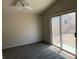 Carpeted bedroom with sliding glass door leading to outdoor space and lots of light at 951 Country Back Rd, Las Vegas, NV 89123