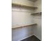 Walk-in closet featuring built in shelving and neutral carpet at 951 Country Back Rd, Las Vegas, NV 89123