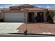 Charming single-story home with a red tile roof, well-maintained landscaping, and a two-car garage at 951 Country Back Rd, Las Vegas, NV 89123