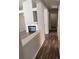 Hallway with hardwood-style flooring leading past a fireplace and into a doorway at 951 Country Back Rd, Las Vegas, NV 89123