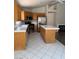 Functional kitchen featuring stainless steel appliances, an island, and white tile floors at 951 Country Back Rd, Las Vegas, NV 89123