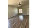 The inviting living room features sleek laminate floors, a ceiling fan, and ample natural light at 951 Country Back Rd, Las Vegas, NV 89123