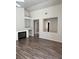 Bright living room with fireplace, built-in shelving, and contemporary wood-look flooring at 951 Country Back Rd, Las Vegas, NV 89123