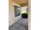 Cozy front porch showcasing a window, textured walls, and inviting concrete flooring at 951 Country Back Rd, Las Vegas, NV 89123