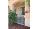 Inviting front porch featuring green foliage, decorative metal railing, and protection from the elements at 951 Country Back Rd, Las Vegas, NV 89123