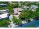 Real estate aerial view of a luxury home with solar panels and a private lot surrounded by trees and green landscape at 9713 Highridge Dr, Las Vegas, NV 89134