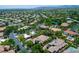 Real estate aerial view of a large residential neighborhood, with winding roads and houses surrounded by lush trees at 9713 Highridge Dr, Las Vegas, NV 89134