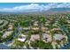 Expansive aerial view of a residential neighborhood featuring mature trees, well-maintained homes, and mountain views at 9713 Highridge Dr, Las Vegas, NV 89134