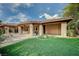 An inviting backyard with artificial turf lawn and covered patio provides ample space for outdoor enjoyment and relaxation at 9713 Highridge Dr, Las Vegas, NV 89134