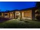 A backyard view showcases an expansive artificial turf lawn, covered patio, and a built-in grill perfect for outdoor entertaining at 9713 Highridge Dr, Las Vegas, NV 89134