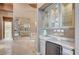 Bathroom view with marble counters, mini-fridge, and views into the bedroom at 9713 Highridge Dr, Las Vegas, NV 89134