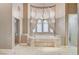 Bright primary bathroom boasts large tub, walk-in shower, and decorative lighting at 9713 Highridge Dr, Las Vegas, NV 89134