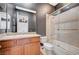 Dark painted bathroom featuring a granite countertop and a shower over tub with a glass enclosure at 9713 Highridge Dr, Las Vegas, NV 89134