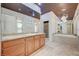 Bathroom features granite counters, dual sinks, a soaking tub, and decorative chandelier lighting at 9713 Highridge Dr, Las Vegas, NV 89134