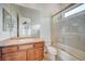 Bright bathroom featuring a granite countertop and a shower over tub with a glass enclosure at 9713 Highridge Dr, Las Vegas, NV 89134