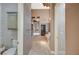 Hallway view of the luxurious bathroom with patterned wallpaper, and access to the shower and toilet rooms at 9713 Highridge Dr, Las Vegas, NV 89134