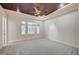 Spacious bedroom with carpet, ceiling fan, and natural light from large windows at 9713 Highridge Dr, Las Vegas, NV 89134