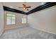 Spacious bedroom with carpet, ceiling fan, and natural light from large windows at 9713 Highridge Dr, Las Vegas, NV 89134