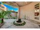 Serene home entrance featuring a central fountain, vine-covered walls, and a tranquil ambiance at 9713 Highridge Dr, Las Vegas, NV 89134