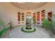 Welcoming home entrance with a lovely courtyard featuring a charming fountain and unique architectural details at 9713 Highridge Dr, Las Vegas, NV 89134