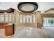 Bright dining room with large windows, elegant chandelier, and granite countertops at kitchen bar at 9713 Highridge Dr, Las Vegas, NV 89134